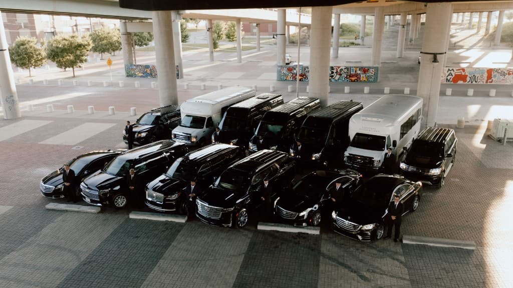 ExclusiveKC full luxury fleet lineup with professional chauffeurs — Kansas City's premier black-car and limo service